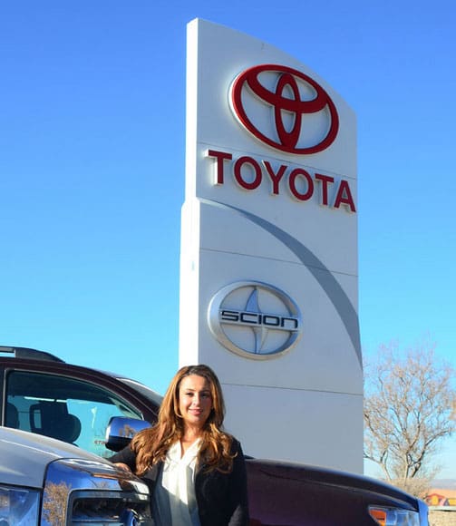 Employee by Toyota sign