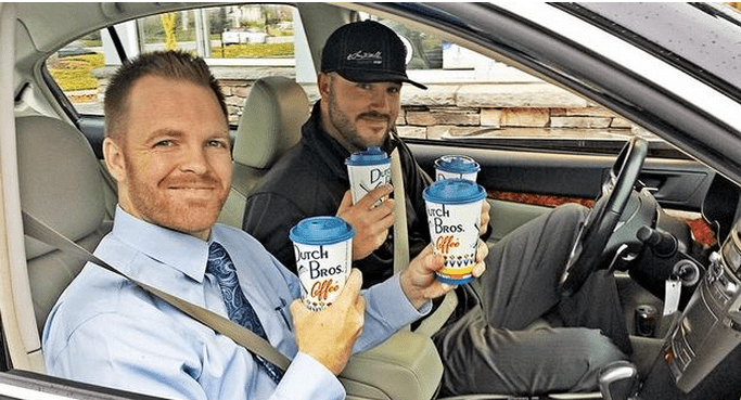 General Manager Ty Leuthold, buys coffee for Matt Hefner for high customer satisfaction score