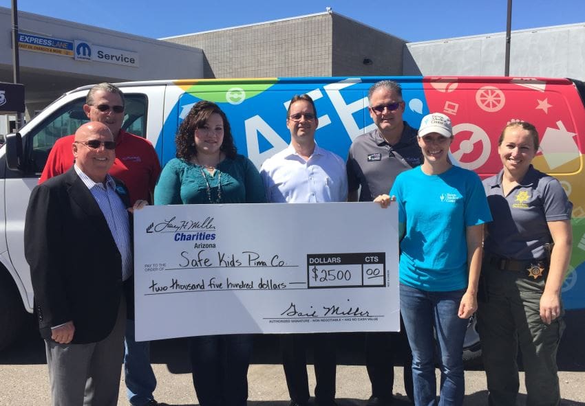 Safe Kids Pima County receive a $2,500 check from Larry H. Miller Charities